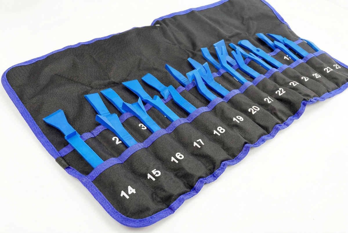 Angled view of blue trim removal tools in a black roll with purple edging