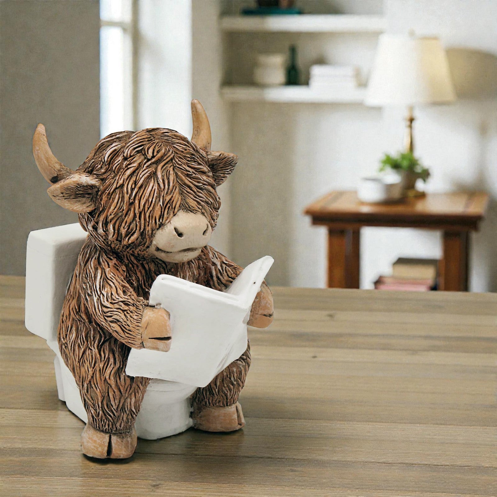 Happy Highland Cow Reading a Newspaper on the Loo Figurine | Bathroom or Toilet Ornament